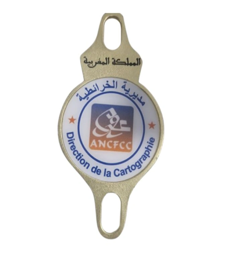 Macaron badge en cuivre pourde la Direction des Cartes de l'ANCFCC - Insigne officiel du Royaume du Maroc